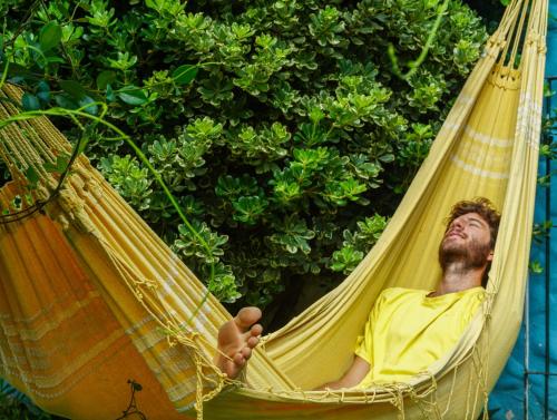 a man is laying in a hammock at Yunga in Salta