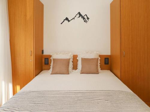 a bedroom with a bed with mountains on the wall at Apartment Alpes et Lac 40 by Interhome in Champex