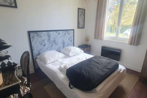a bedroom with a bed with a pillow on it at Villa proche plage de l'Amélie - 3057 in Soulac-sur-Mer