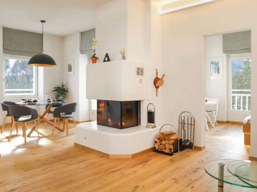 a living room with a fireplace and a table at Apartment Alpes et Lac 40 by Interhome in Champex