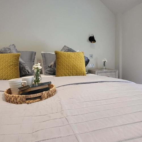a large bed with yellow pillows and a tray on it at Big Star in Kelling