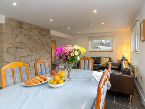 a table with food and flowers on it in a kitchen at Holiday Home Muir Edge by Interhome in Nethy Bridge