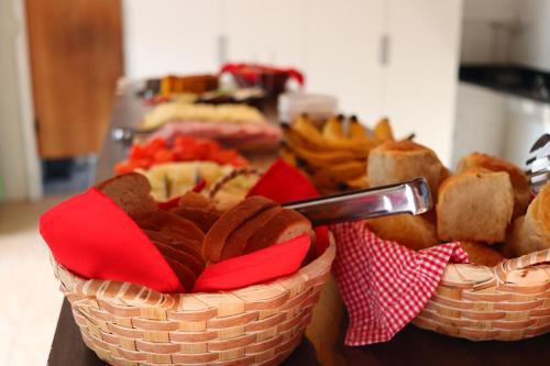 two baskets filled with different types of food on a table at Garden 437 Suítes in Florianópolis
