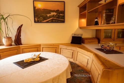 a kitchen with a table with a picture on the wall at GORI Boutique Apartments – Tirol in Reutte