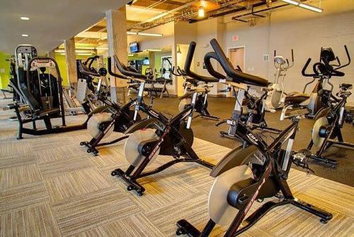 a gym with a bunch of cardio bikes at 100 Year Old Historic Brick 2BR Loft High Ceiling3 in Durham
