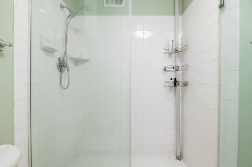 a shower with a glass door in a bathroom at Sj Elite Loft Sleek Sophistication in San Jose