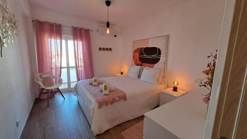 a bedroom with a bed with two candles on it at Albufeira Oura Beach Apartment in Albufeira
