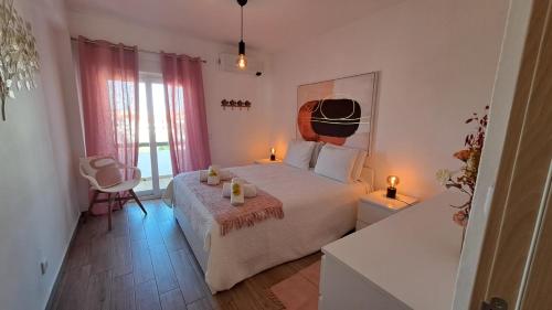 a bedroom with a bed with two candles on it at Albufeira Oura Beach Apartment in Albufeira