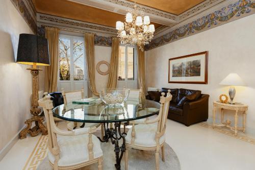 a dining room with a glass table and chairs at Casa San Domenico in Mantova