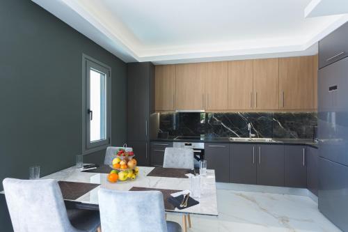 a kitchen with a table with fruit on it at Marina Apartments in Kardamili