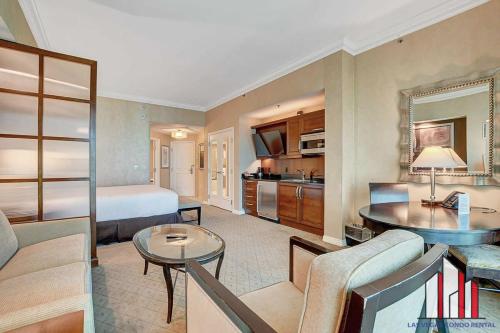 a hotel room with a bed and a living room at MGM Signature-38-617 Top floor F1 View Balcony in Las Vegas