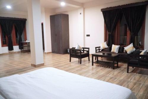 a living room with a couch and a table at ROYALTY GLOBAL HOMESTAY in Shillong