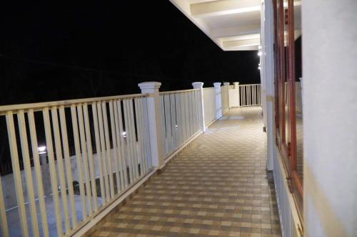 a balcony with a white railing at night at ROYALTY GLOBAL HOMESTAY in Shillong