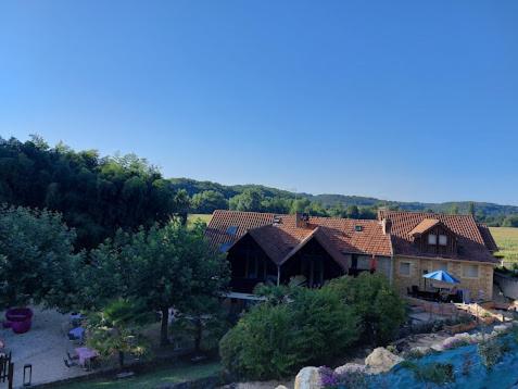 an aerial view of a house with a pool at Le Moulin du Porteil in Campagne