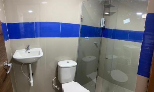 a bathroom with a shower and a toilet and a sink at HOTEL DI MAR in Cartagena de Indias