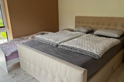 a bed in a bedroom with two pillows on it at Familientraum in Großweitzschen
