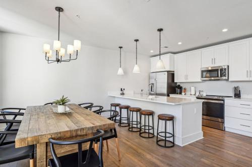 an open kitchen with a wooden table and chairs at The Eleanor New Orleans in New Orleans