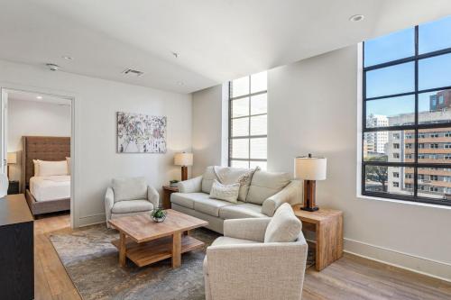 a living room with a couch and a table at The Eleanor New Orleans in New Orleans
