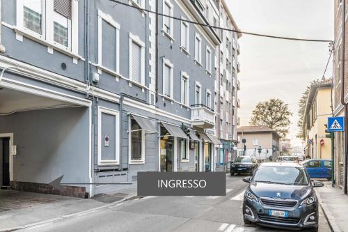 a car parked on a street next to a building at La Perla Rooms in Saronno