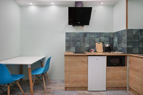 a kitchen with a counter and a table and chairs at Honeymoon Apartments in Old Tbilisi in Tbilisi City