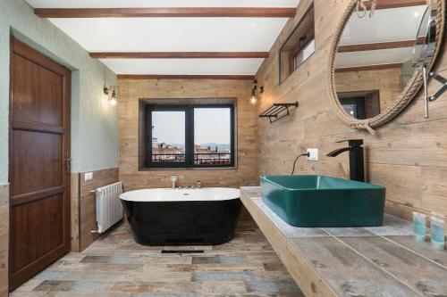 a bathroom with a tub and a large mirror at Honeymoon Apartments in Old Tbilisi in Tbilisi City