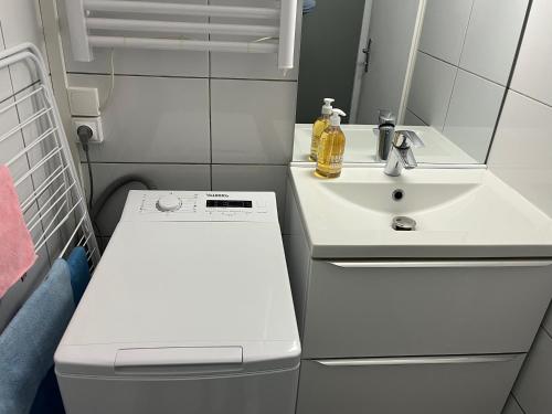 a small bathroom with a sink and a toilet at Studio cocooning cap d’Agde in Cap d'Agde