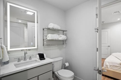 a bathroom with a sink and a toilet and a mirror at The Eleanor New Orleans in New Orleans
