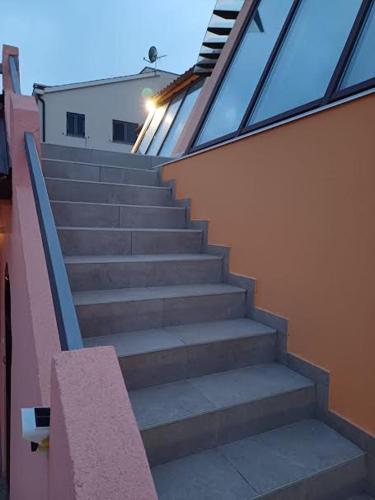 a set of stairs in front of a building at Apartmani Delas 2 in Pješčana Uvala 