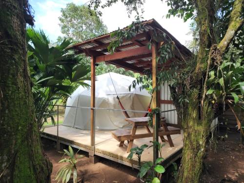 a gazebo with a chair and a tent at Glamping Naioth in Guápiles