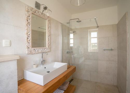 a bathroom with a sink and a shower and a mirror at Villa Moonlight in Poreč