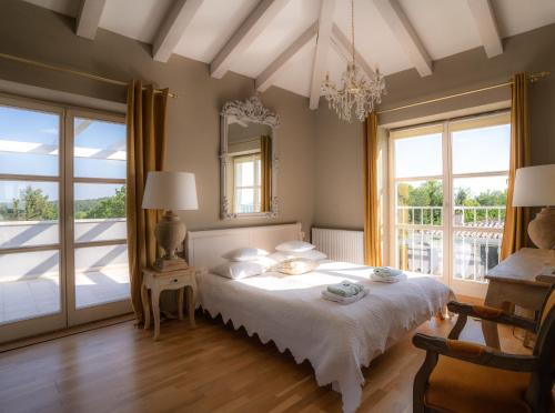 a bedroom with a bed with a mirror and windows at Villa Moonlight in Poreč