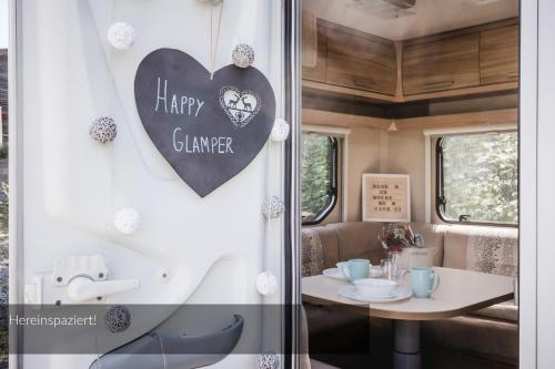 a window with a heart sign on a train at Strandbad Steckborn mit Herberge, Camping & Glamping in Steckborn