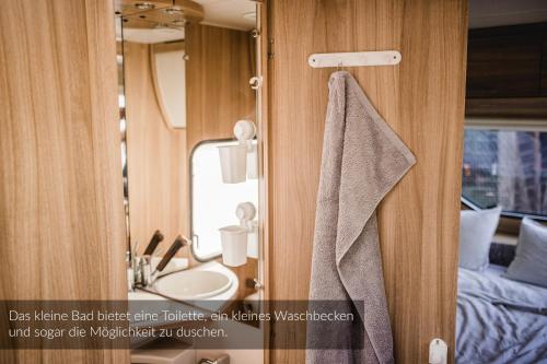 a bathroom with a sink and a mirror at Strandbad Steckborn mit Herberge, Camping & Glamping in Steckborn