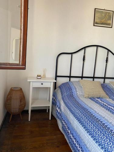 a bedroom with a bed and a table with a mirror at Apartments Hortenzija in Maslinica