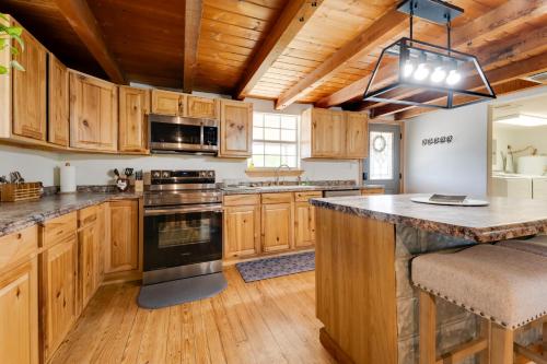 a kitchen with wooden cabinets and a large counter top at Pet-Friendly Cabin on 3 Acres 7 Mi to Uvalde! in Uvalde