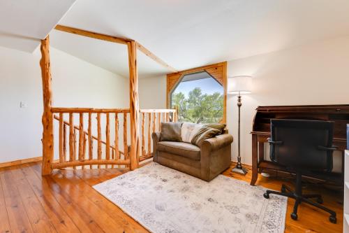 a living room with a chair and a piano at Pet-Friendly Cabin on 3 Acres 7 Mi to Uvalde! in Uvalde