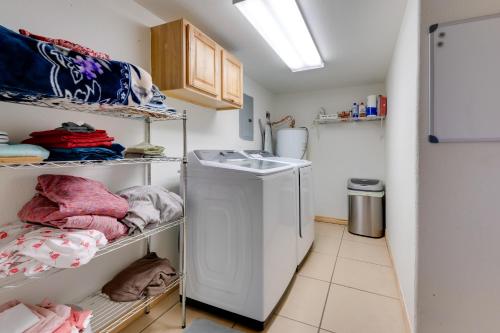 a kitchen with a sink and a laundry room at Pet-Friendly Cabin on 3 Acres 7 Mi to Uvalde! in Uvalde