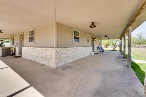 an empty porch of a house with a stone wall at Pet-Friendly Cabin on 3 Acres 7 Mi to Uvalde! in Uvalde