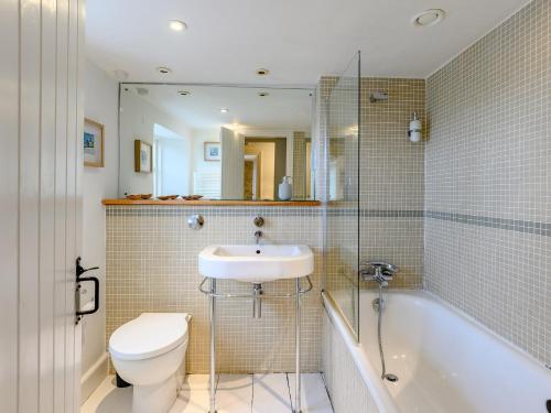 a bathroom with a sink and a toilet and a tub at 3 Bed in Isle of Purbeck IC081 in Langton Matravers