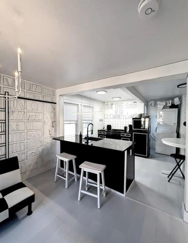 a kitchen with a counter and stools in a room at The 2D Spot! in Buffalo