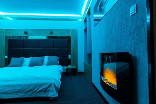 a bedroom with a bed and a fireplace at GLAMOUR - Restaurant & SPA in Przeźmierowo