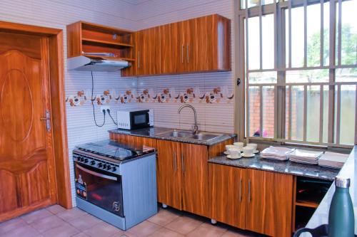 a kitchen with a stove and a sink in it at MONTANA STAY in Ruhengeri