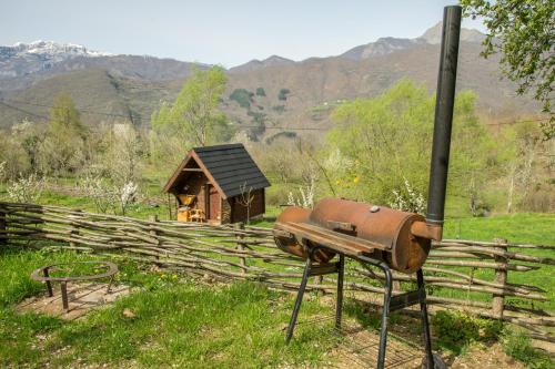 a rusted out stove in front of a house at Djurdjevina Family Farm in Kolašin
