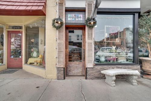 a storefront with a bench in front of a store at Vintage Downtown Laramie Apartment with Deck! in Laramie