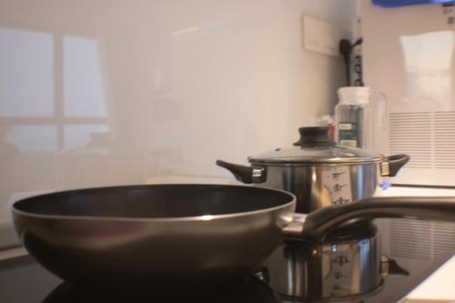 a bowl on a counter next to a pot and a tea kettle at Prime Comfort Seaview with Netflix and Water Filter near Georgetown in Jelutong