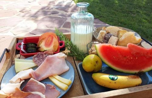 a picnic table with plates of food and a bottle of milk at Hotel El Teular in Sueca