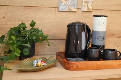 a coffee maker and a plate of food on a counter at Green Nest Room with private bathroom in Eastbourne