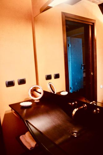 a bathroom with a sink and a mirror at Podere Boschetto R&B in Bologna