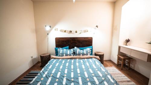 a bedroom with a bed with a blue comforter at Heart of the city II in Braşov