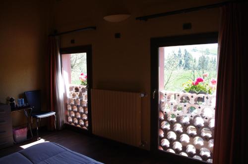 a bedroom with a door open to a garden at Podere Boschetto R&B in Bologna